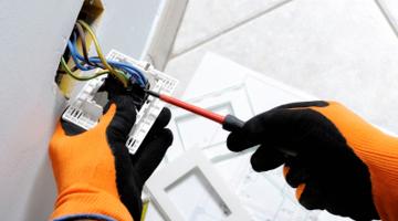A person's hands doing an electrical job
