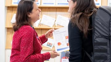 Photo of Friends of Moorfields staff giving out patient leaflets