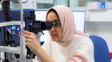 Staff member using a slit lamp