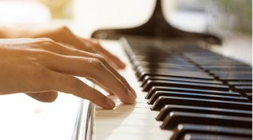 Hands of a person playing piano
