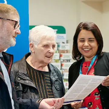 Photo of staff interacting with patients outside the Health Hub