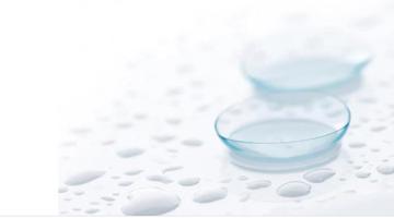 A pair odf contact lenses on a wet surface