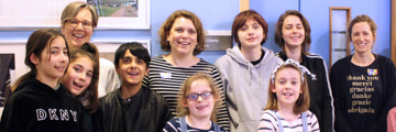 Group of people, of different ages, smiling at the camera