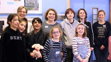 Group of people, of different ages, smiling at the camera