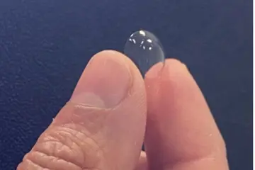 Fingers Holding Contact Lens